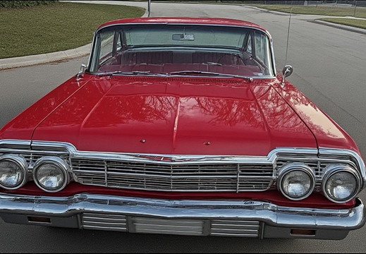  A front-facing view of a vintage red Chevrolet Impala
