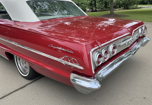 The rear quarter panel and taillight section of a vintage Chevrolet Impala.