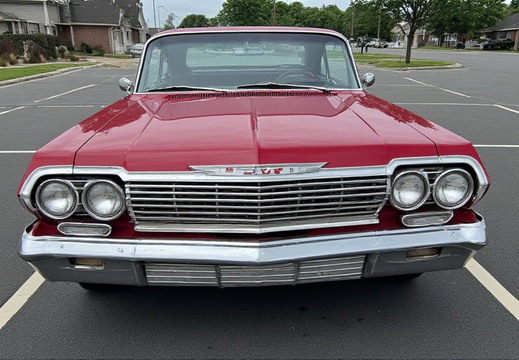 A classic red Chevrolet Impala from the early 1960s
