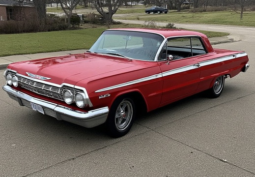 An image of a two-door Chevrolet Impala, painted in a vibrant, glossy red