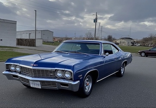 A striking, classic blue Chevrolet Impala coupe